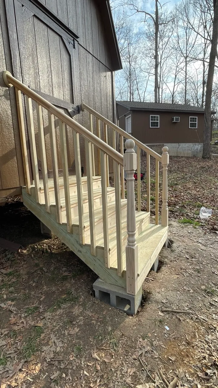 The finished stairs seen from the side, showing the stringers, bearing blocks, and rail posts