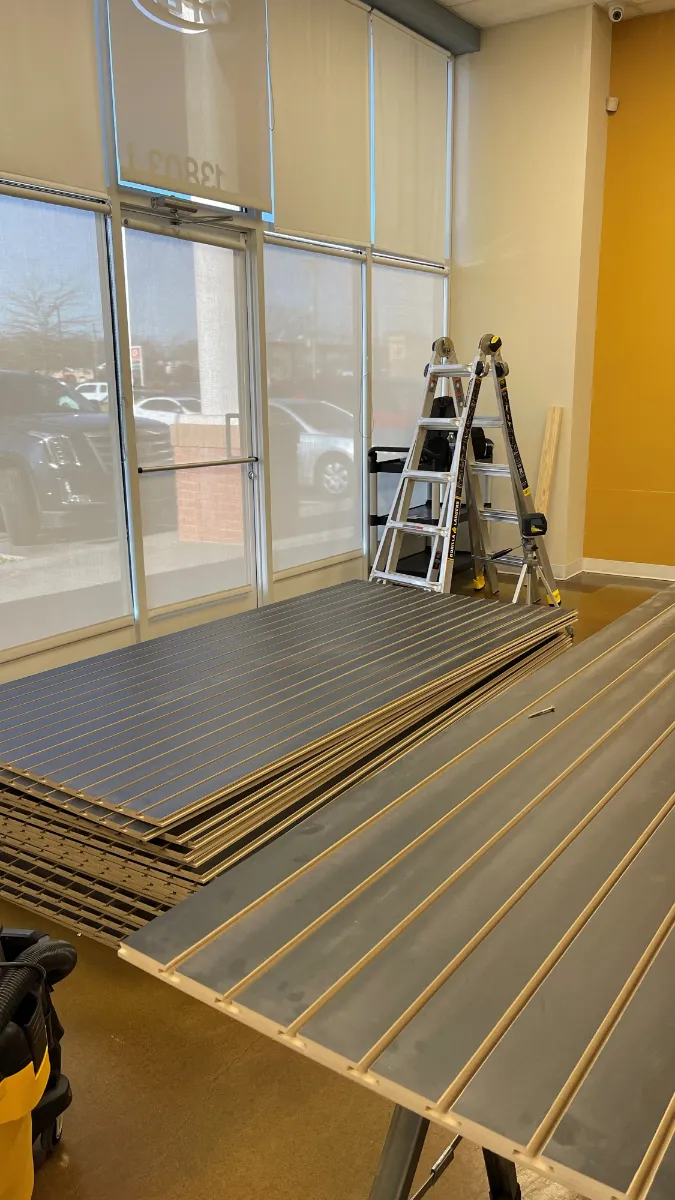 Slat panels stacked on trestles in front of the shop windows, ready to go up