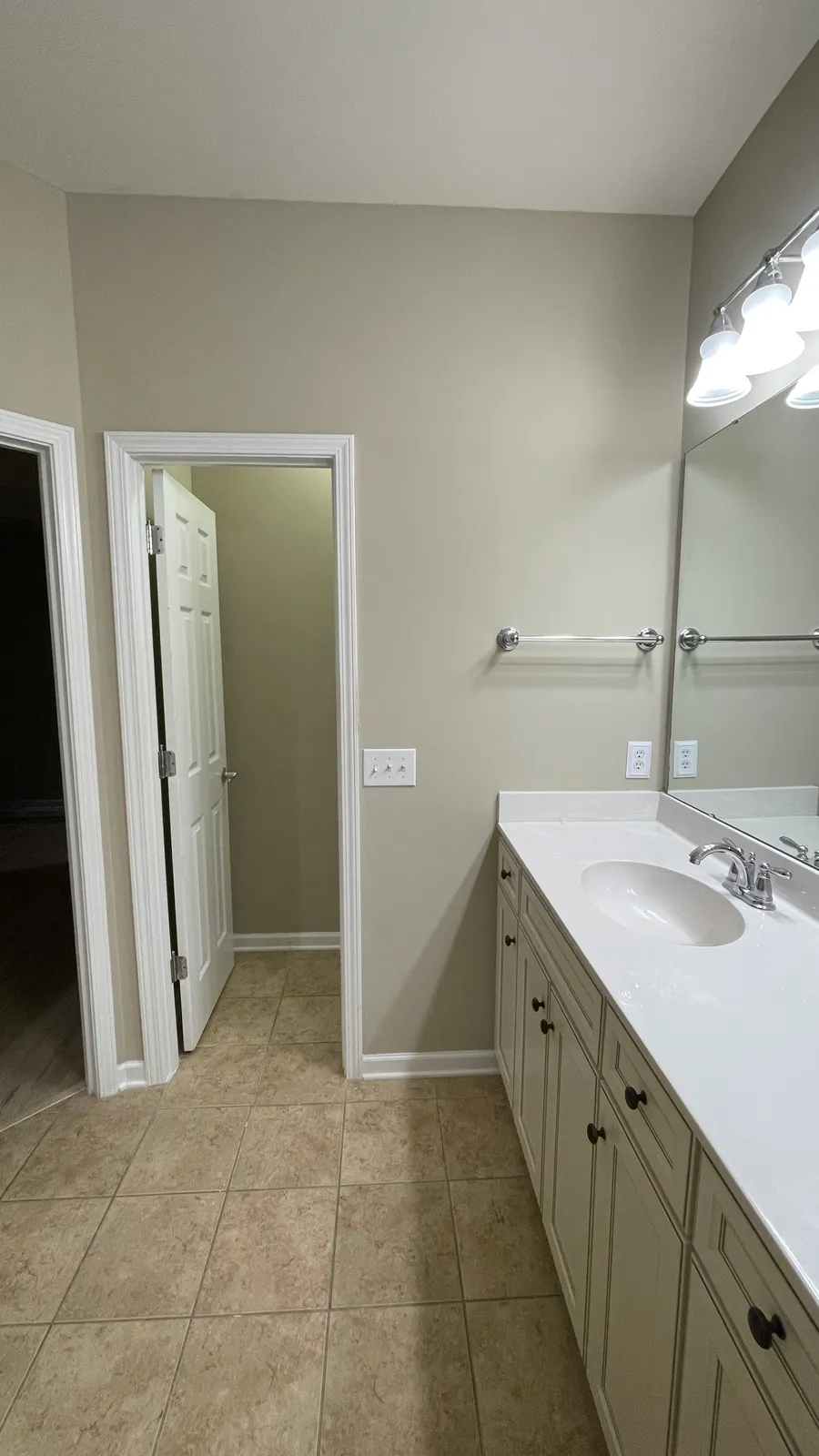 Guest bathroom with neutral walls, vanity, and tiled floor