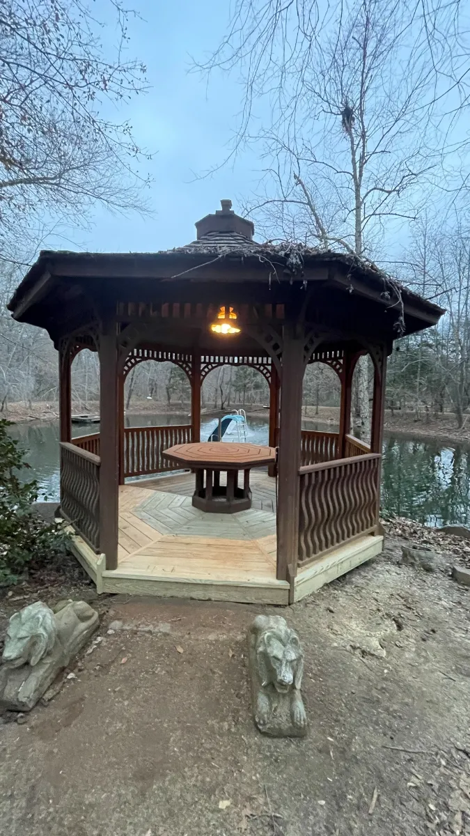 A gazebo with a new timber floor laid in a chevron pattern around a central table