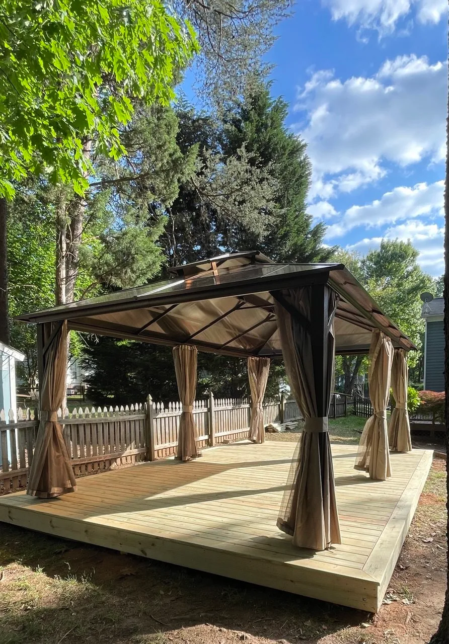 Completed deck with a hard-top gazebo and tied-back curtains