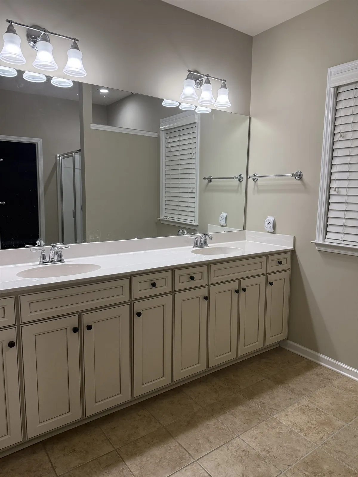 The same primary bathroom repainted in a warm neutral